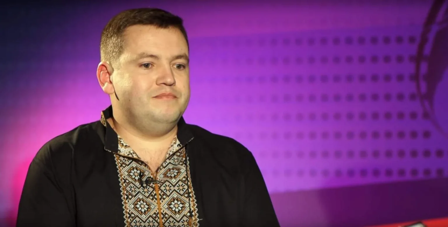 Чоловік у вишиванці на фіолетовому фоні