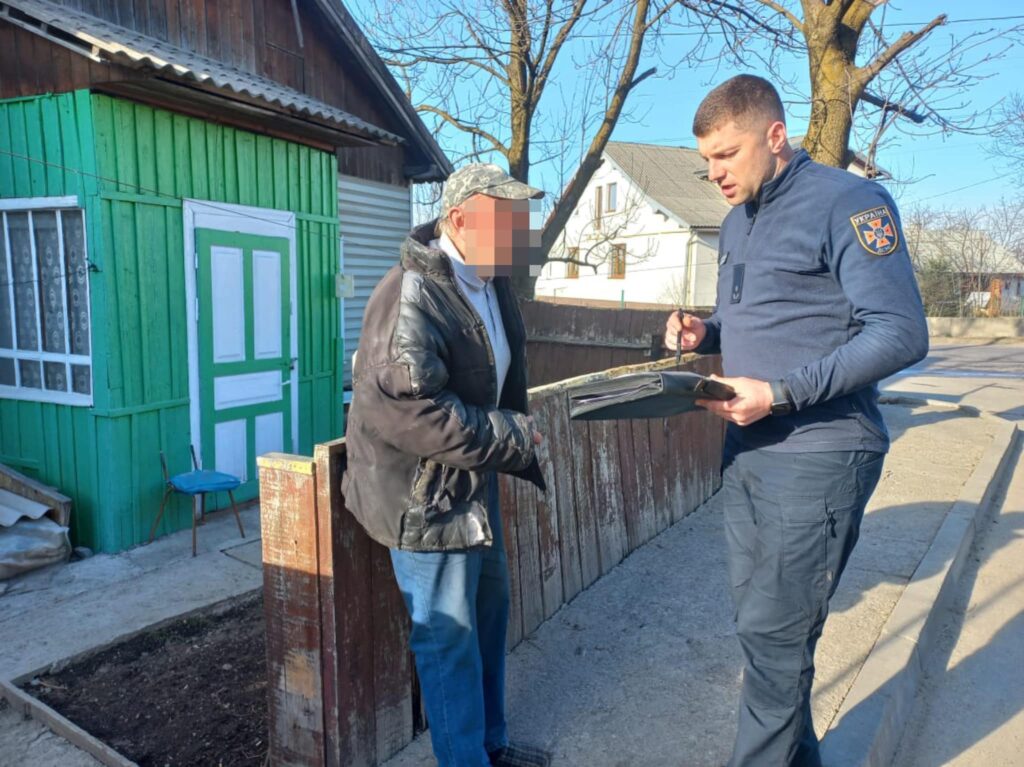 Співробітник ДСНС спілкується з місцевим жителем біля дому