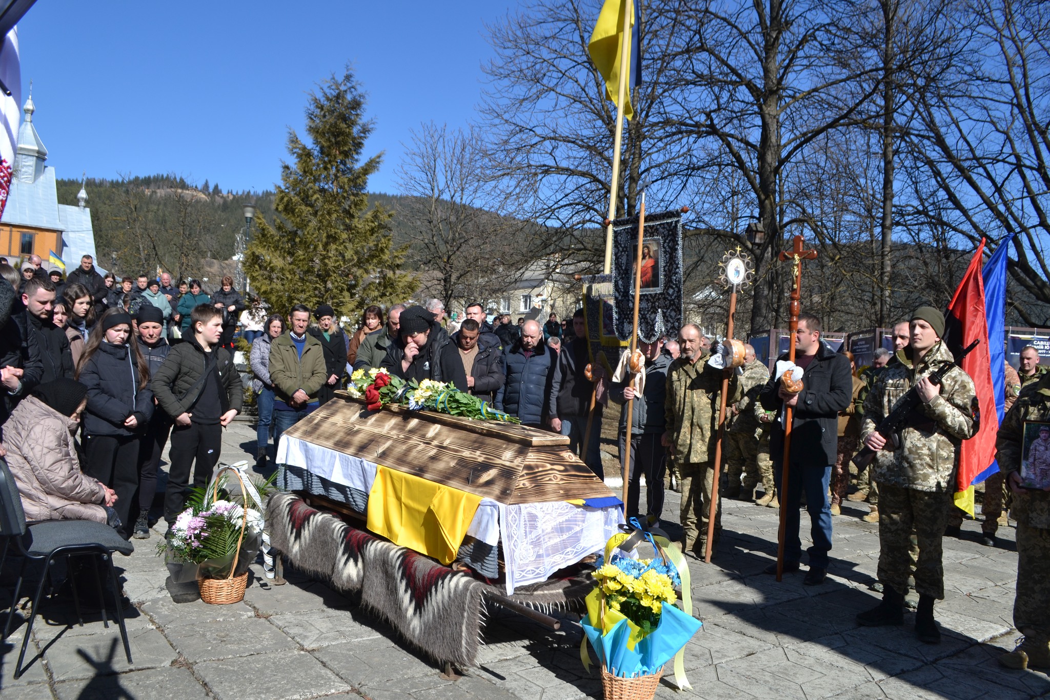 Громадськість прощається з померлим на відкритому повітрі.