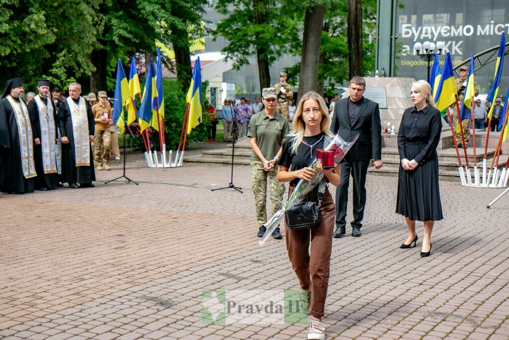 Церемонія покладання квітів біля прапорів України.