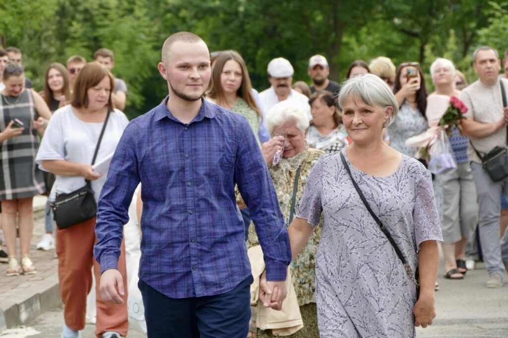 Люди йдуть вулицею на святі.
