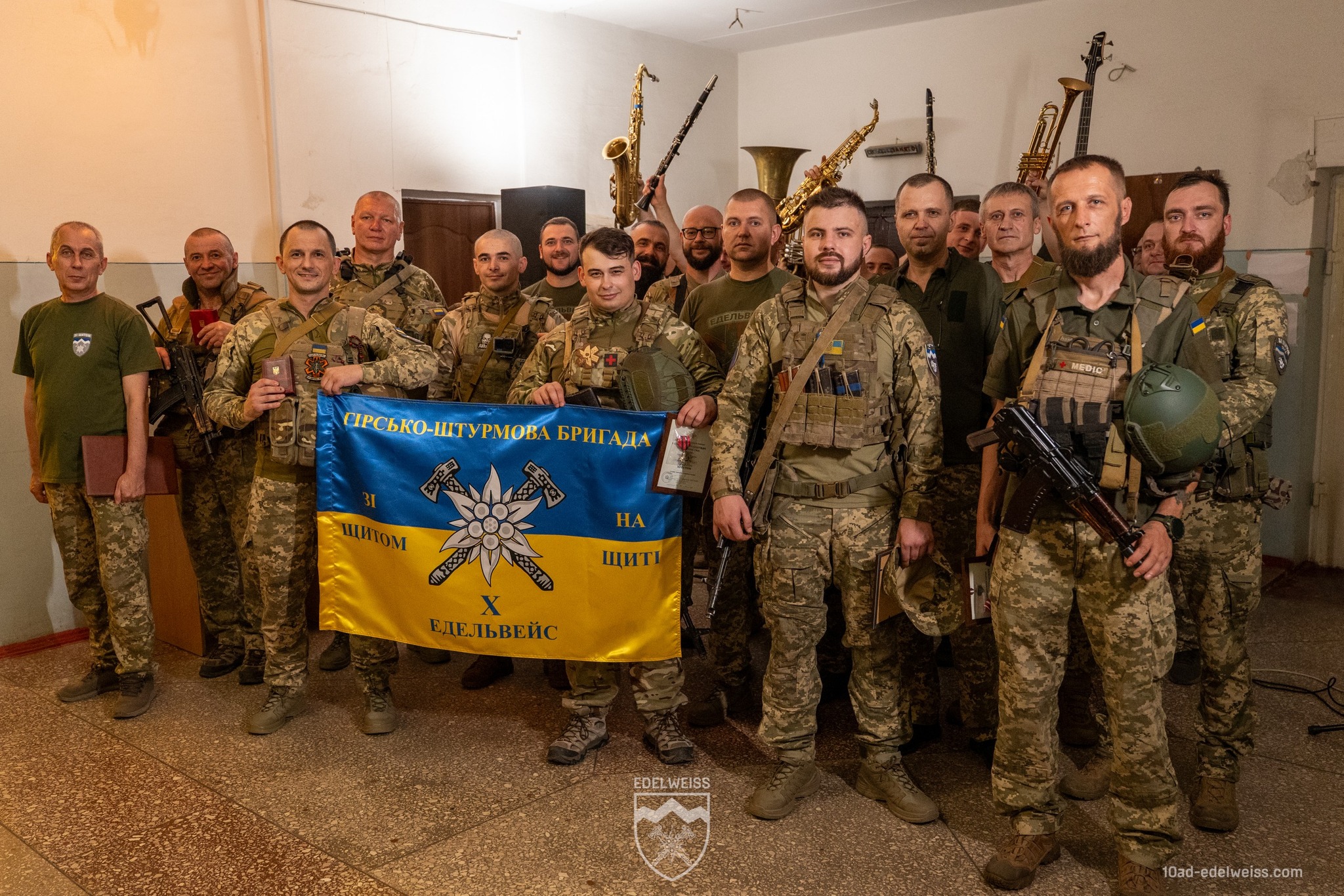 Військові з банером гірсько-штурмової бригади.