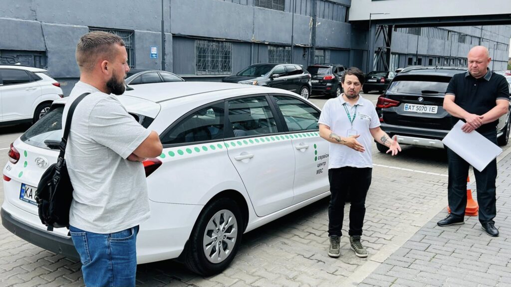 Обговорення перед службовим автомобілем на вулиці