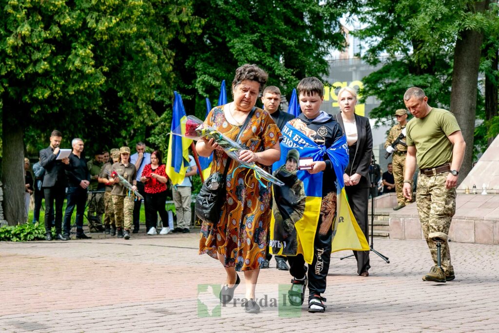 Вшанування захисника з прапорами України.