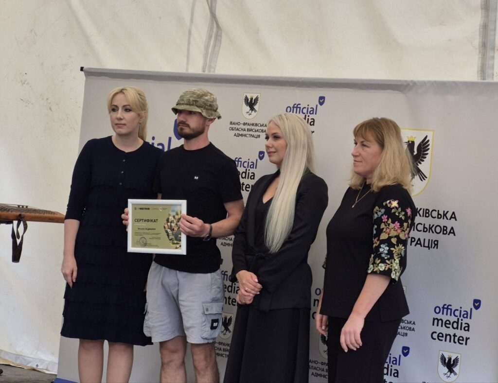 Вручення сертифіката чоловікові на офіційному заході.