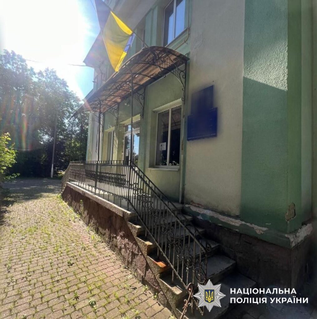 Поліцейський відділок з українським прапором на фасаді.