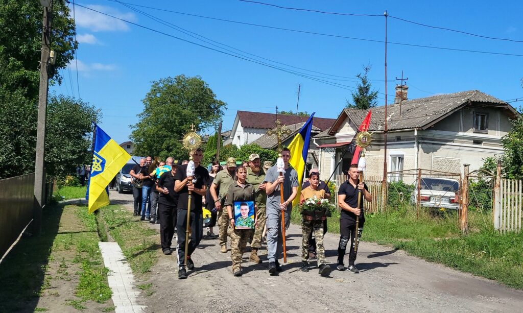 Люди з прапорами України йдуть вулицею