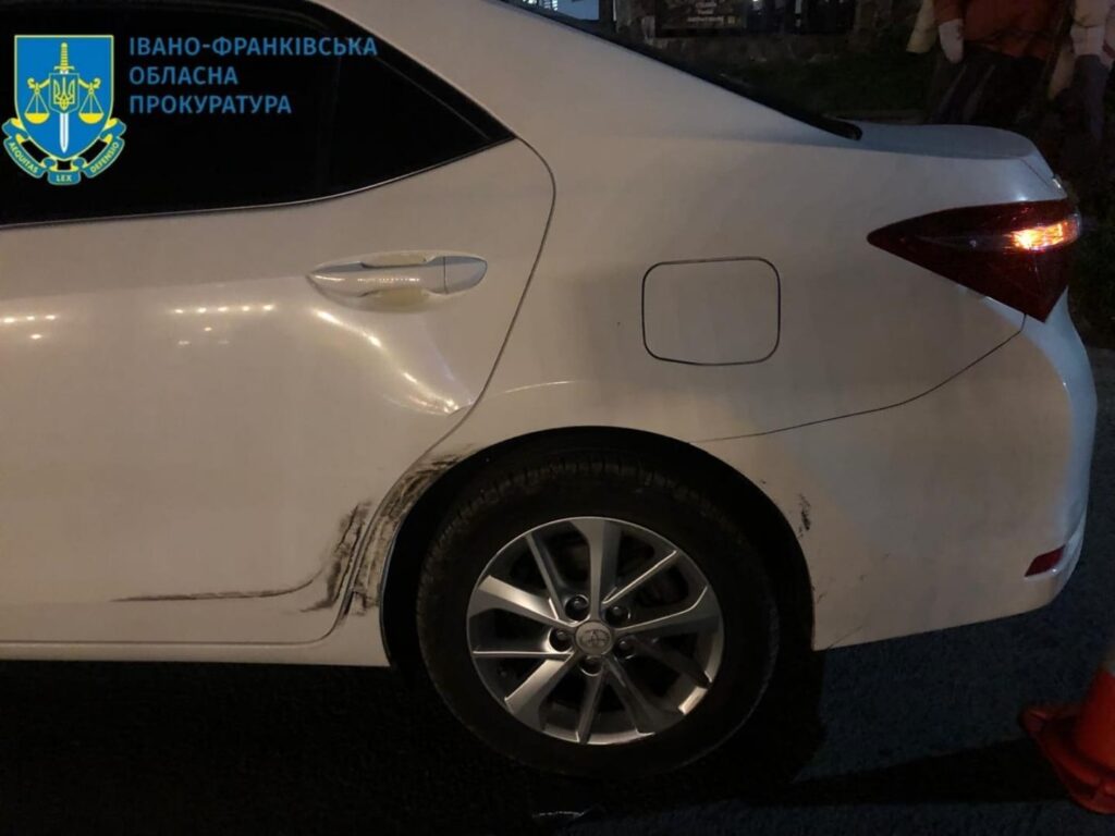 Пошкоджене авто на парковці, вечірній час