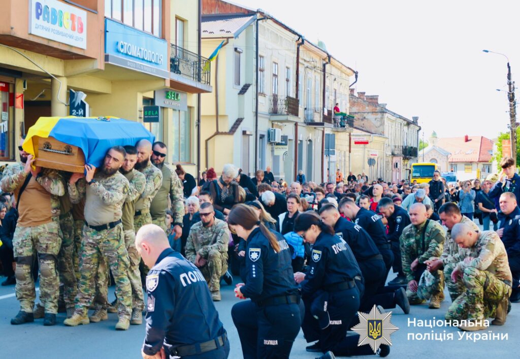 Українські військові несуть труну вулицею міста