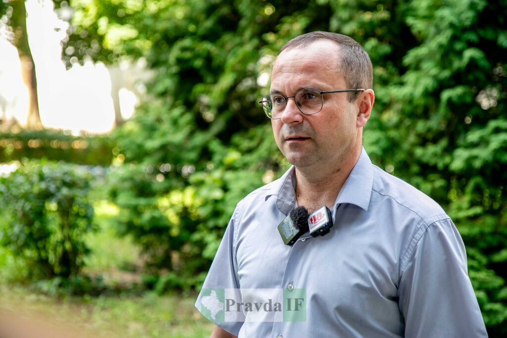 Людина у парку дає інтерв'ю на камеру.