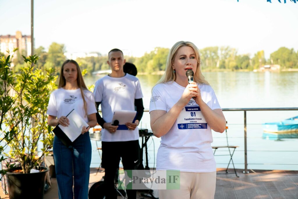 Жінка виступає на заході біля річки.