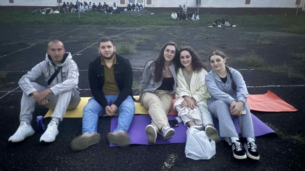 Група молодих людей відпочиває на вулиці