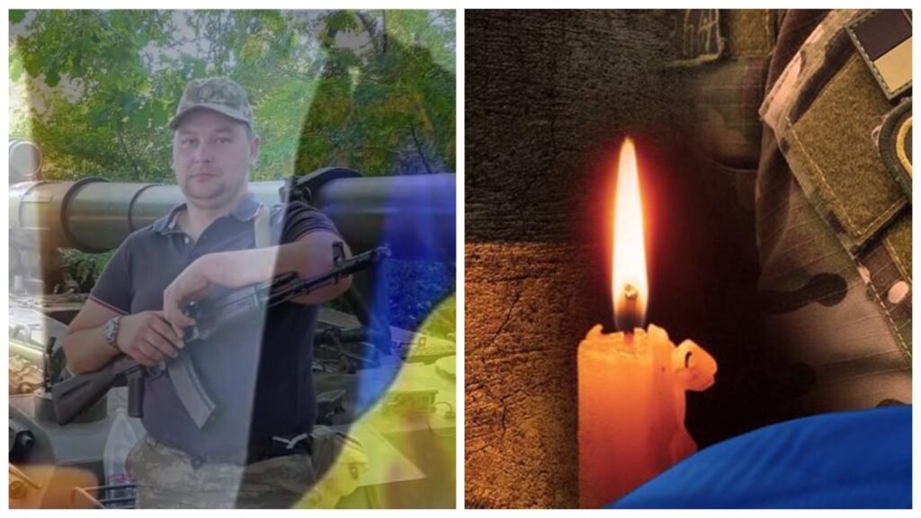 Військовий тримає зброю біля прапора, свічка горить
