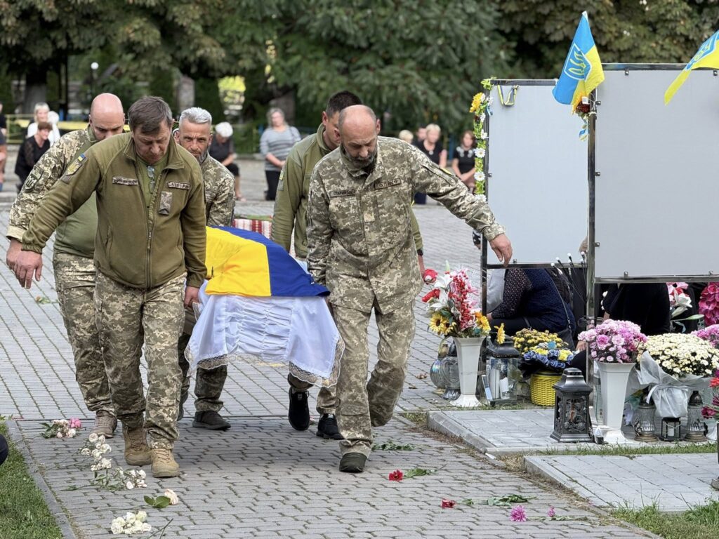 Військові несуть труну з прапором України на похороні