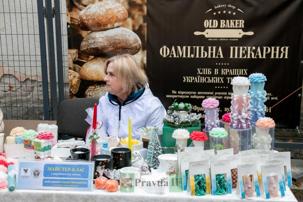 Жінка на ярмарку декоративних свічок в пекарні.