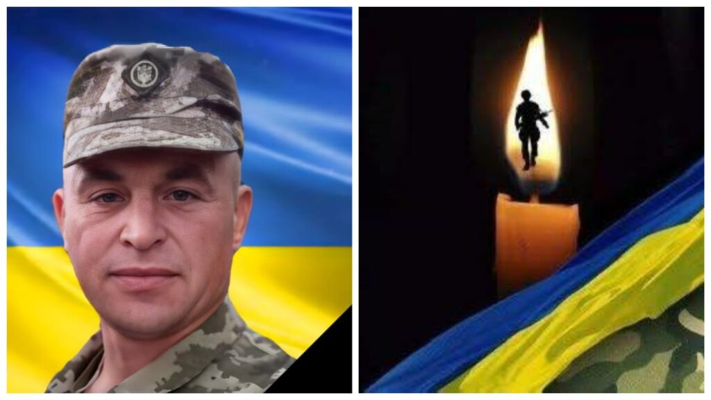 Український військовий на фоні національного прапора.