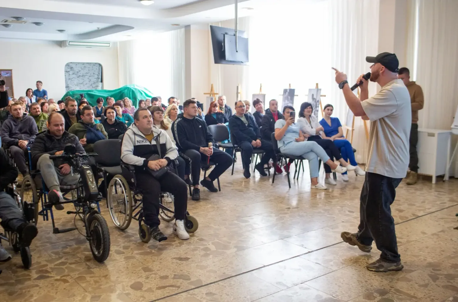 Лектор виступає перед аудиторією людей у залі