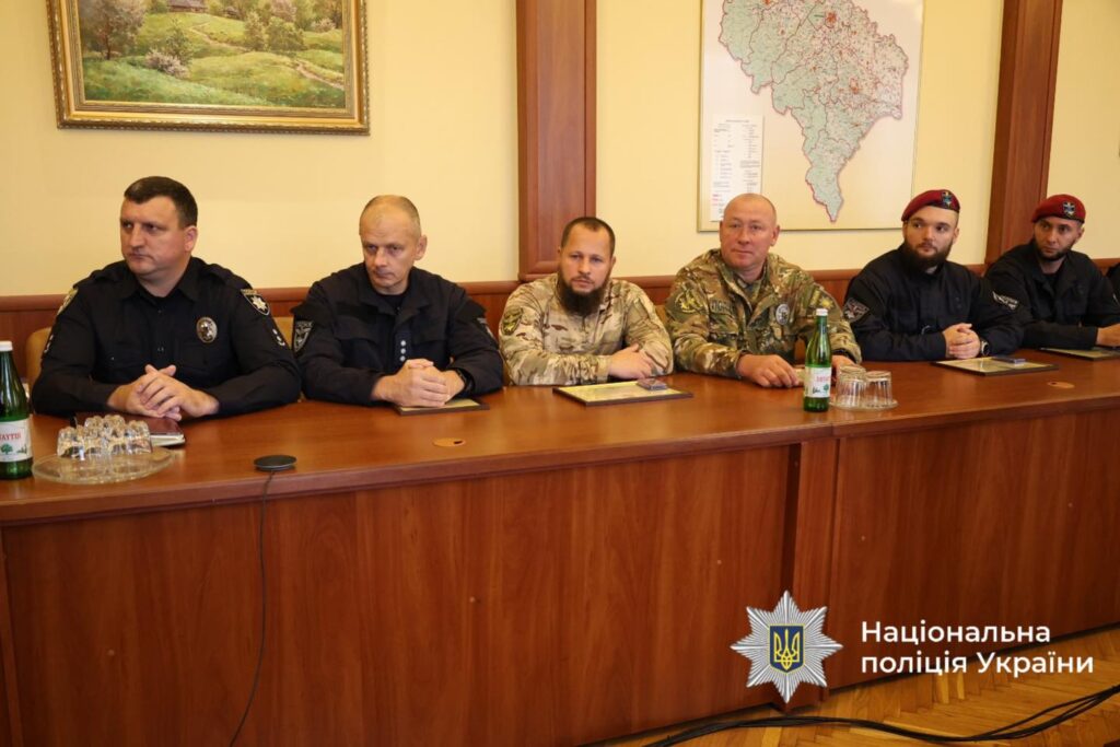 Чоловіки у формі сидять за столом.