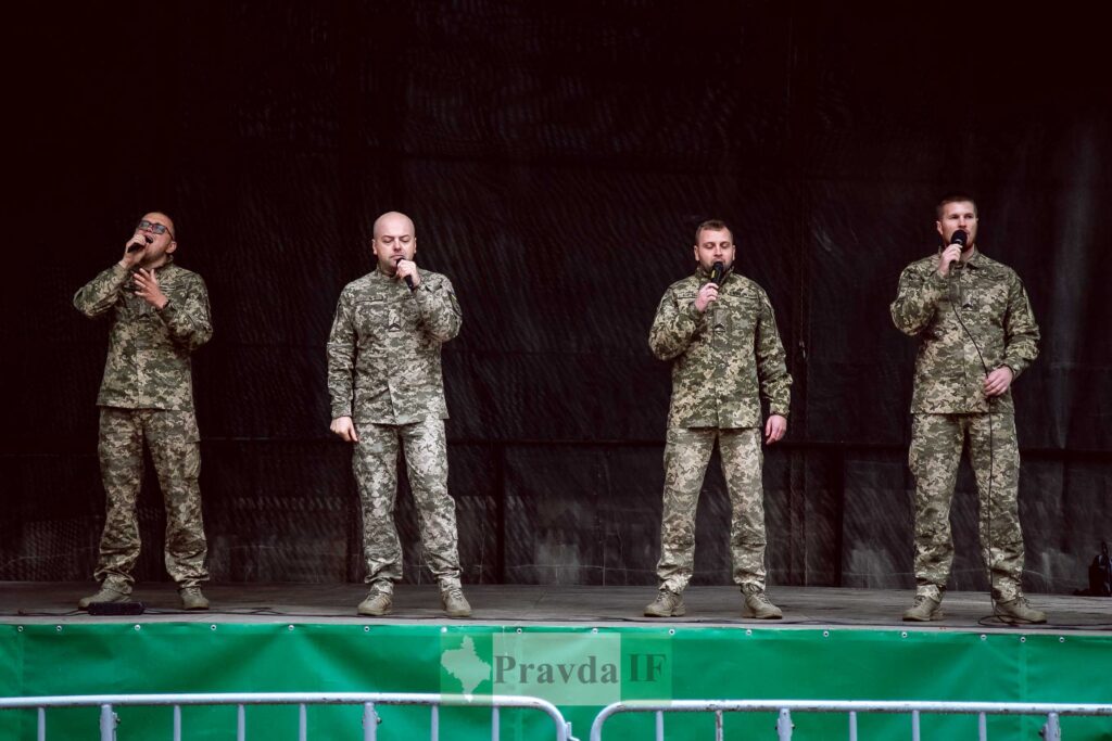 Співочий квартет у військовій формі на сцені.
