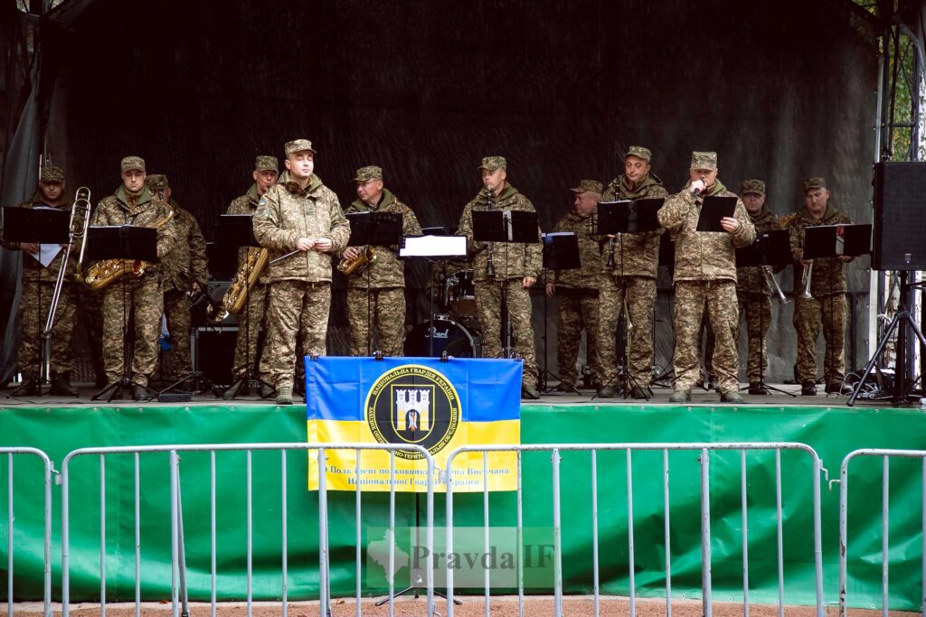 Військовий оркестр на сцені з прапором України.