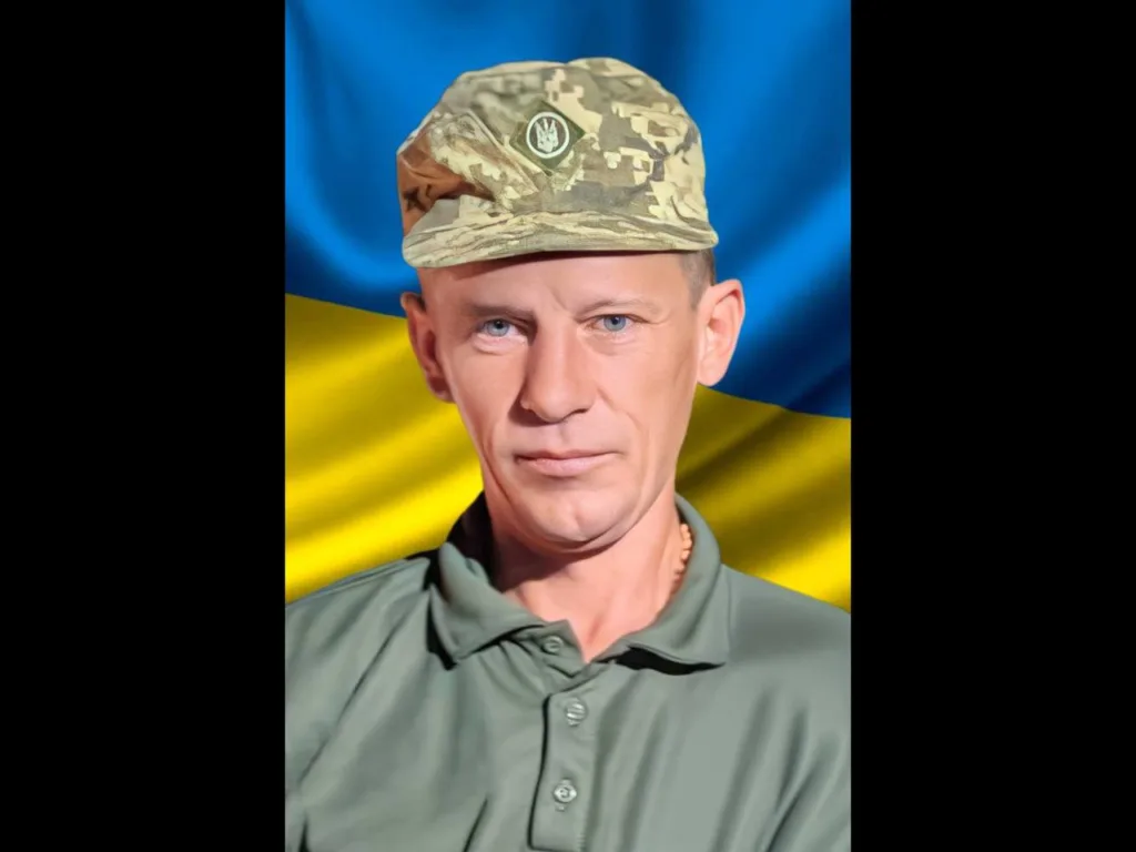 Український військовий на тлі прапора України