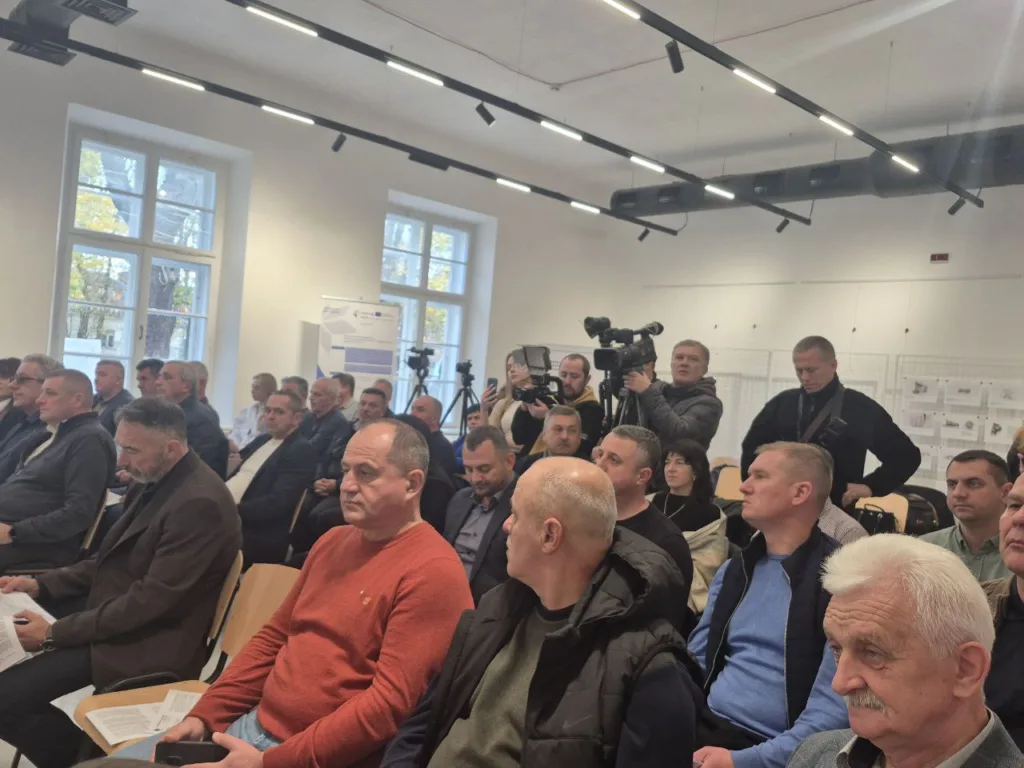 Люди на конференції у сучасній залі
