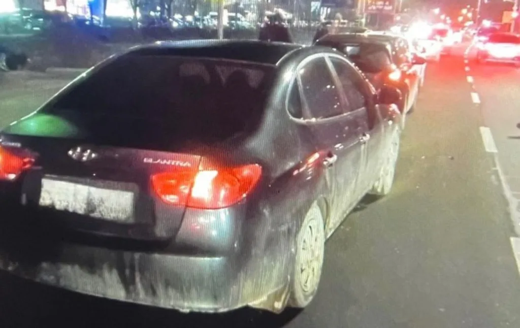 Брудний чорний автомобіль на міській вулиці вночі