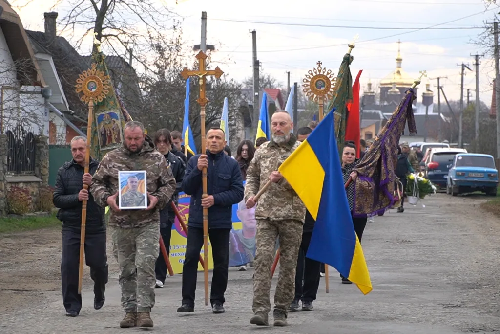 Процесія з українськими прапорами та релігійними символами
