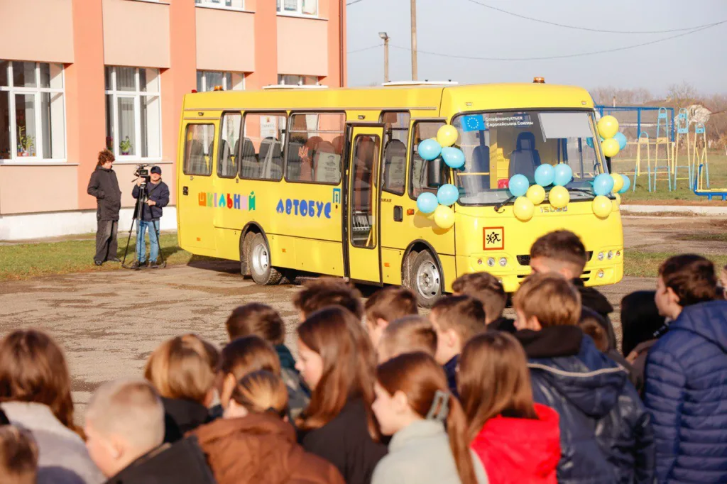 Діти біля жовтого шкільного автобуса
