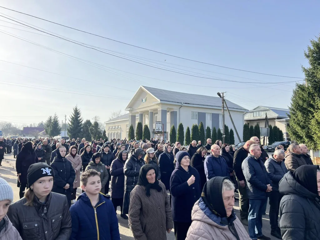 Люди зібралися на вулиці біля будівлі