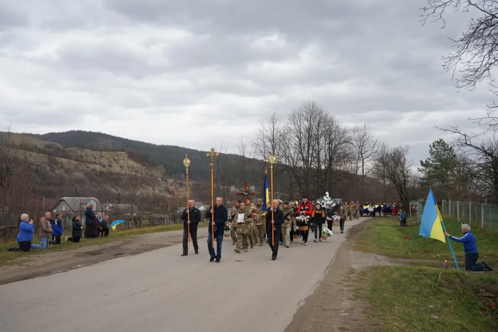 Похоронна процесія військових з українським прапором
