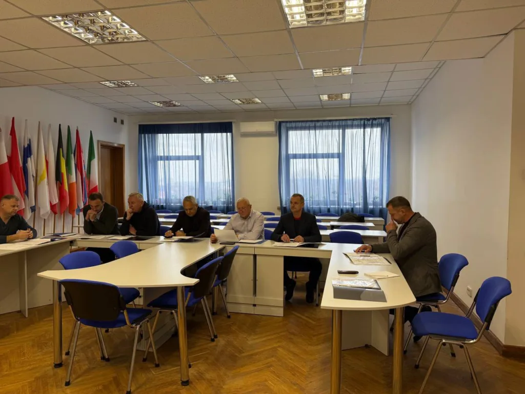 Засідання чоловіків у конференц-залі з прапорами