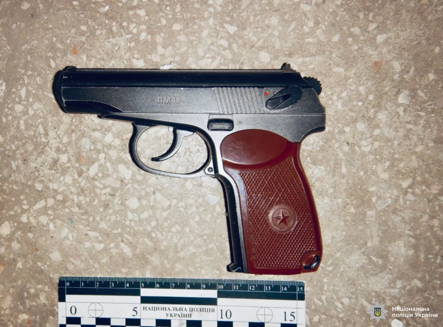 Пістолет на підлозі з лінійкою для вимірювання