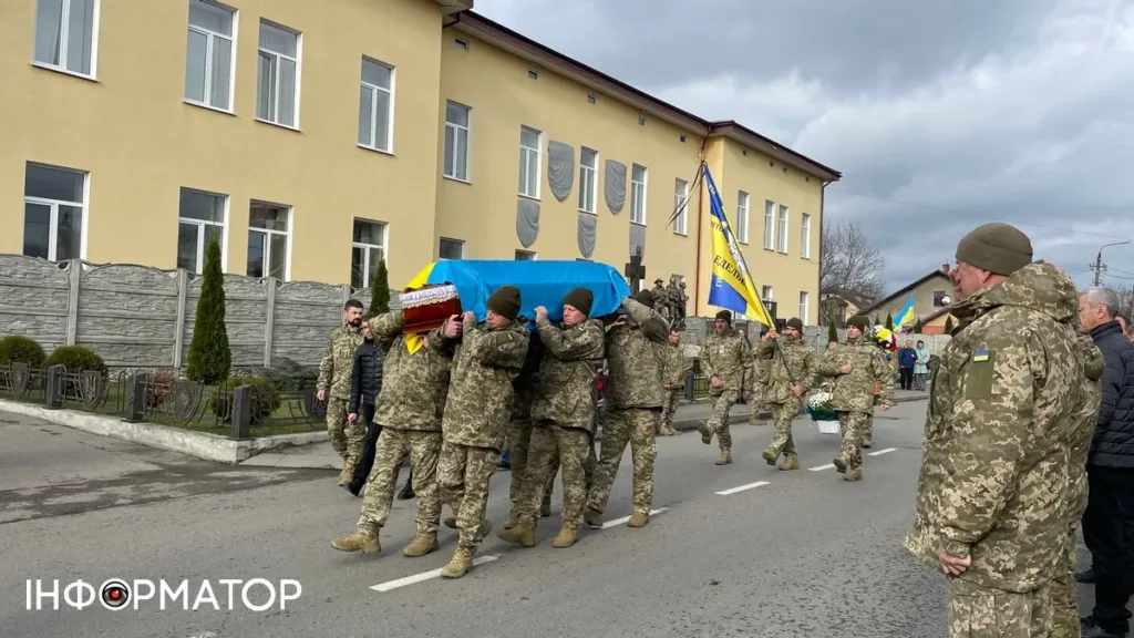 Військові несуть труну з прапором України