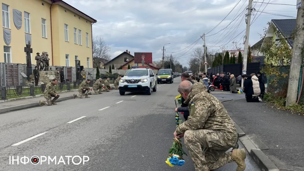 Військові та люди стоять на колінах під час церемонії