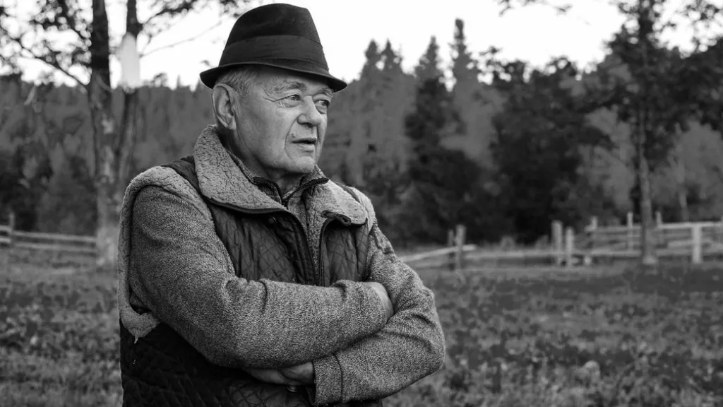 Похилий чоловік у капелюсі на природі