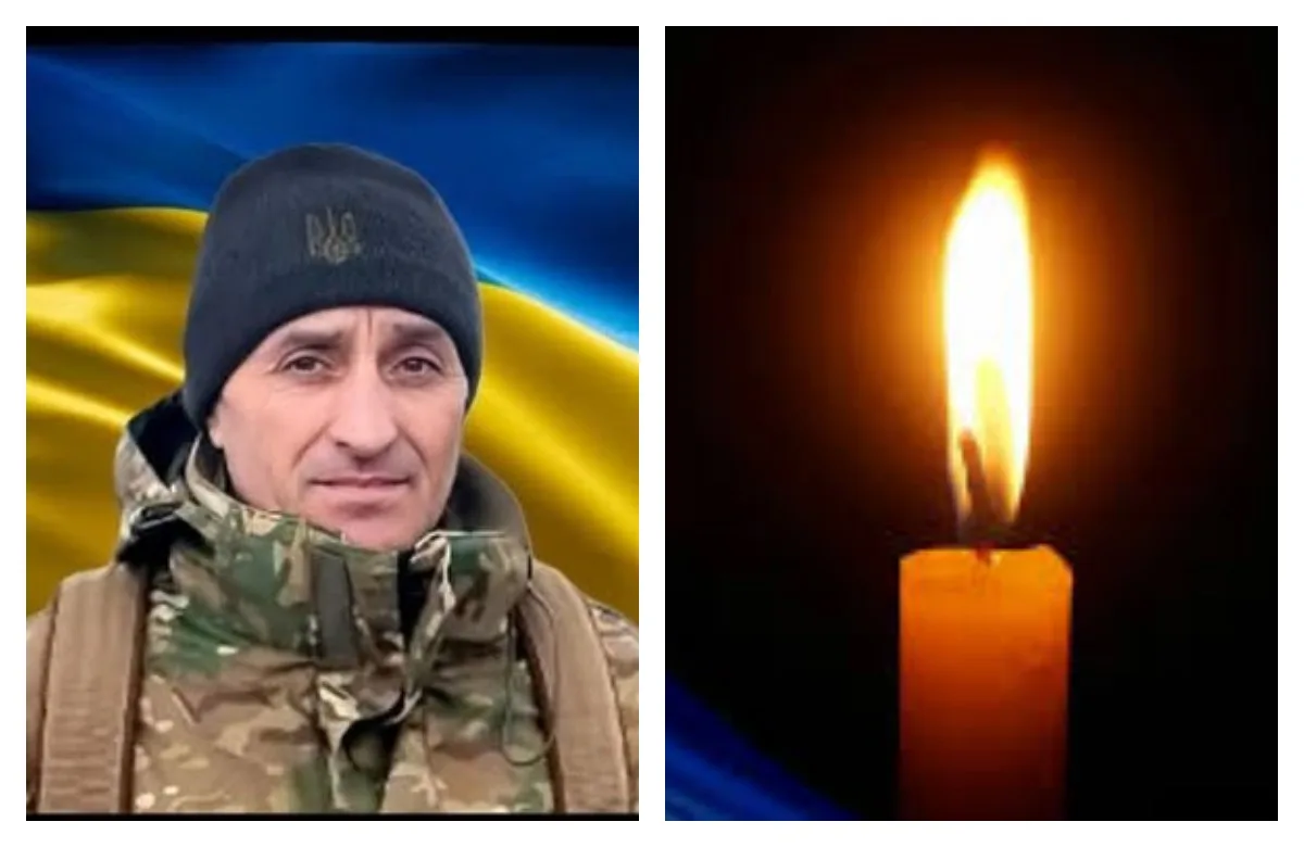 Український військовий та свіча пам’яті на фоні прапора