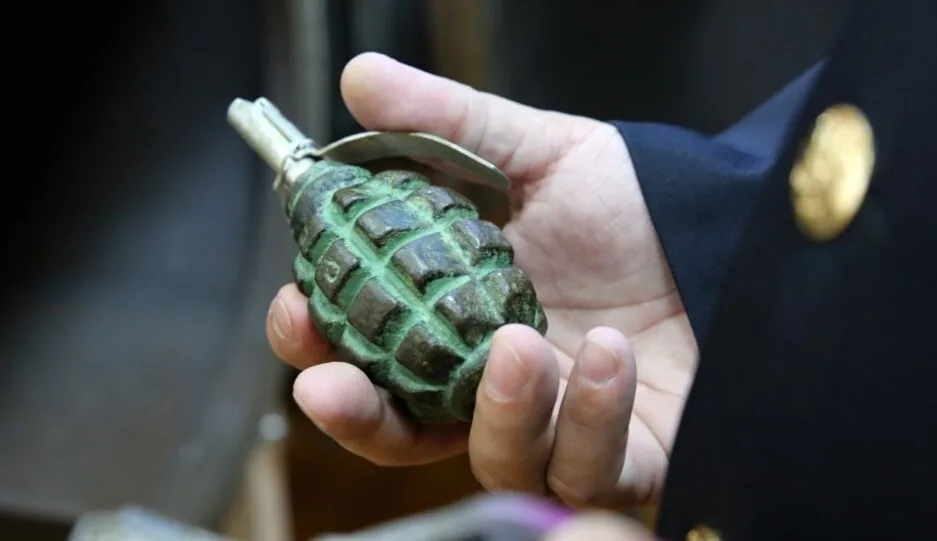 Людина тримає ручну гранату в руці