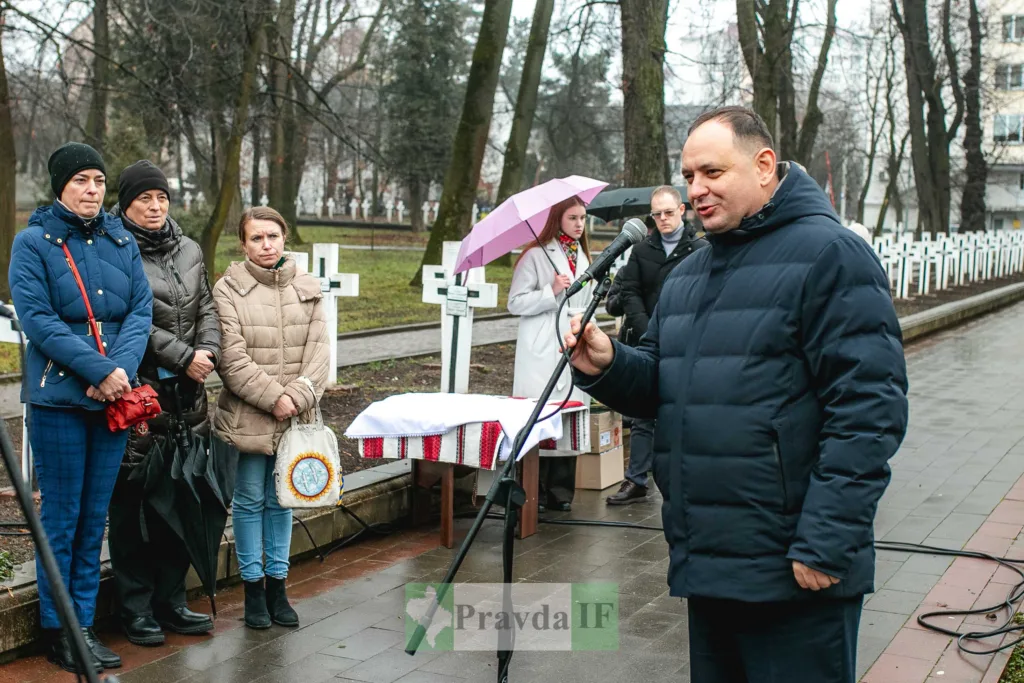 Чоловік говорить на мітингу біля пам’ятних хрестів