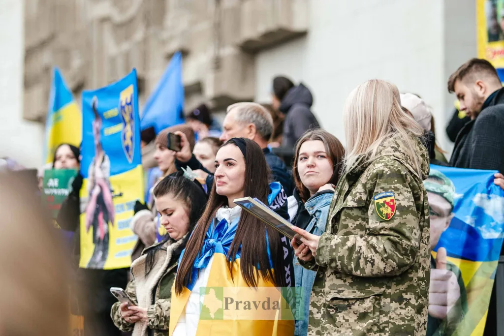 Люди з українськими прапорами на мітингу