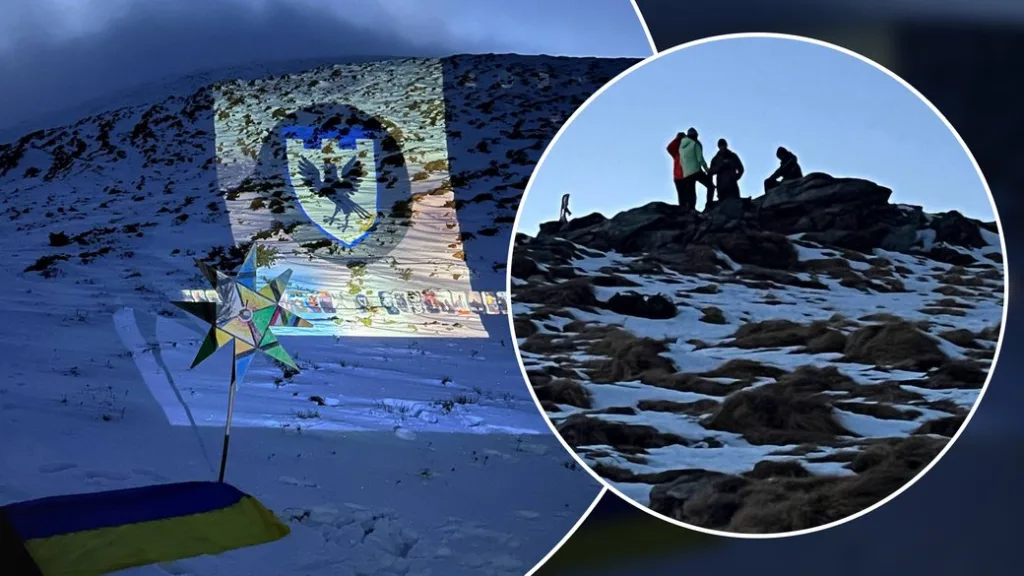 Гори взимку з проєкцією герба на снігу