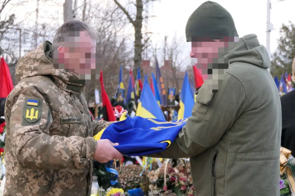 Військові тримають український прапор на церемонії