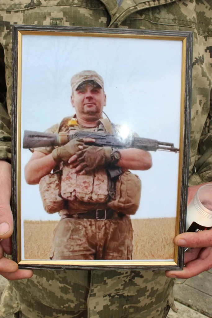 Військовий тримає фото загиблого солдата