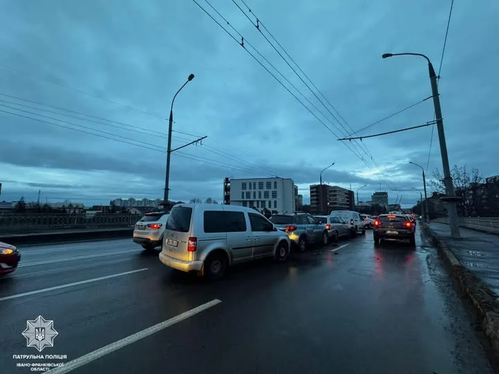 Автомобільний затор на мокрій міській дорозі ввечері