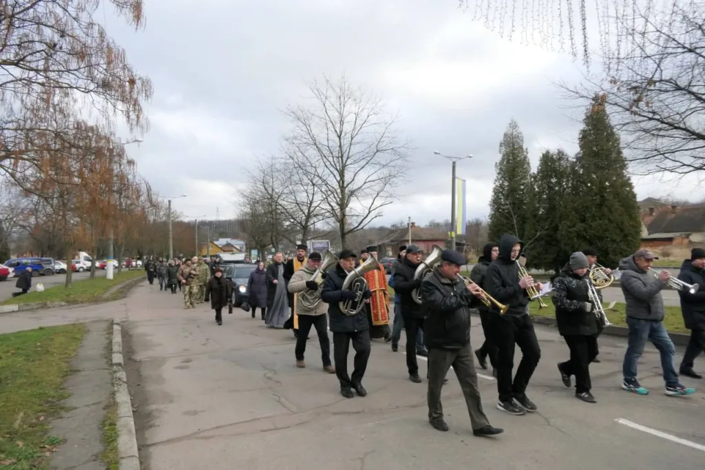 Духовий оркестр веде ходу вулицею міста