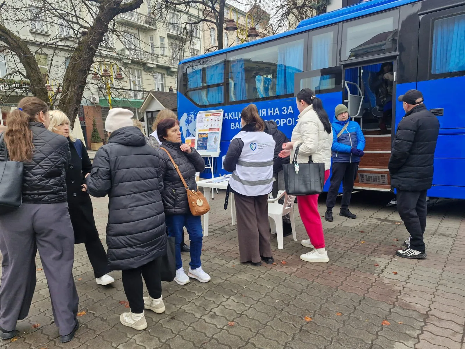 Люди біля мобільного медичного пункту на вулиці