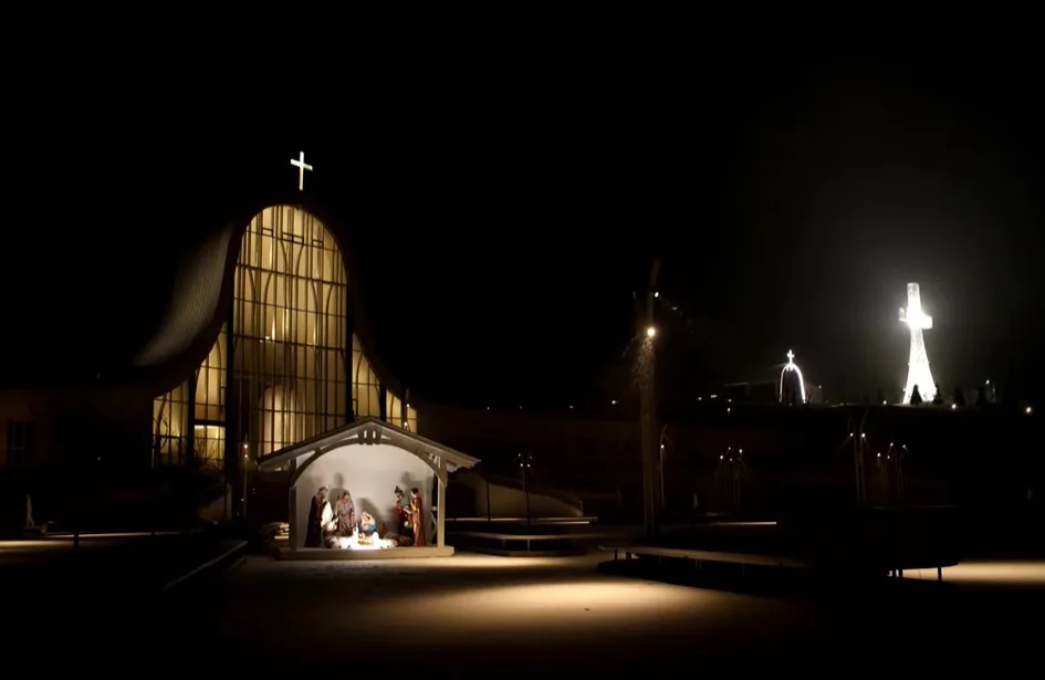 Нічна сцена Різдва перед освітленою церквою