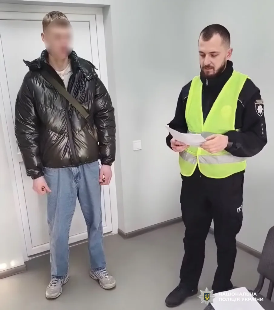 Поліцейський спілкується з чоловіком у відділку поліції