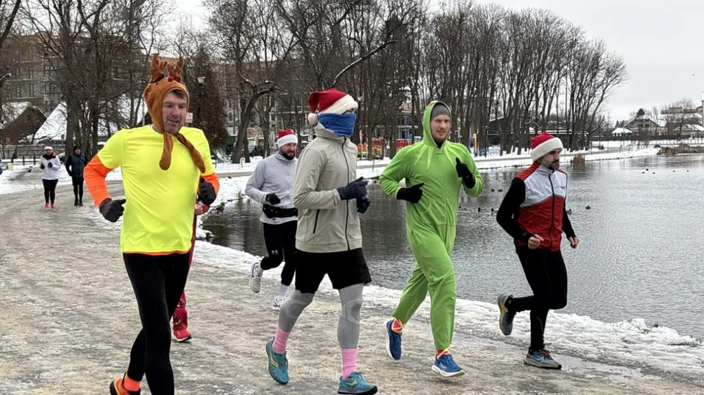 Люди біжать у костюмах зимовим парком