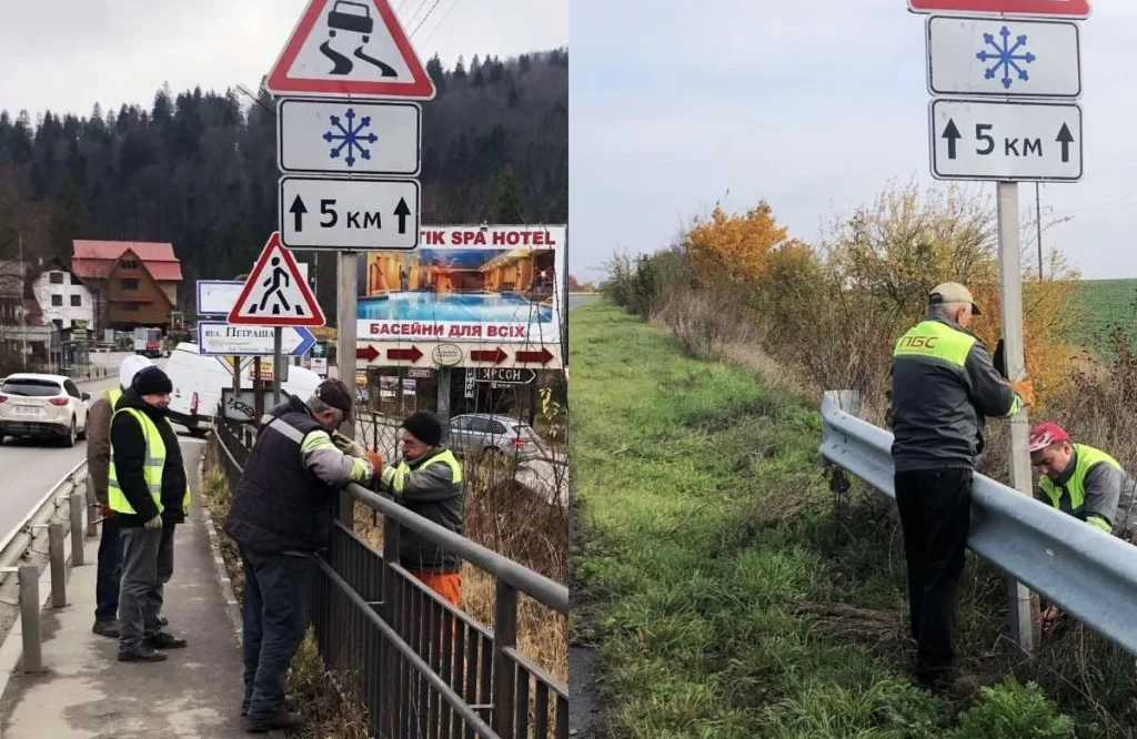 Робітники встановлюють дорожні знаки вздовж траси